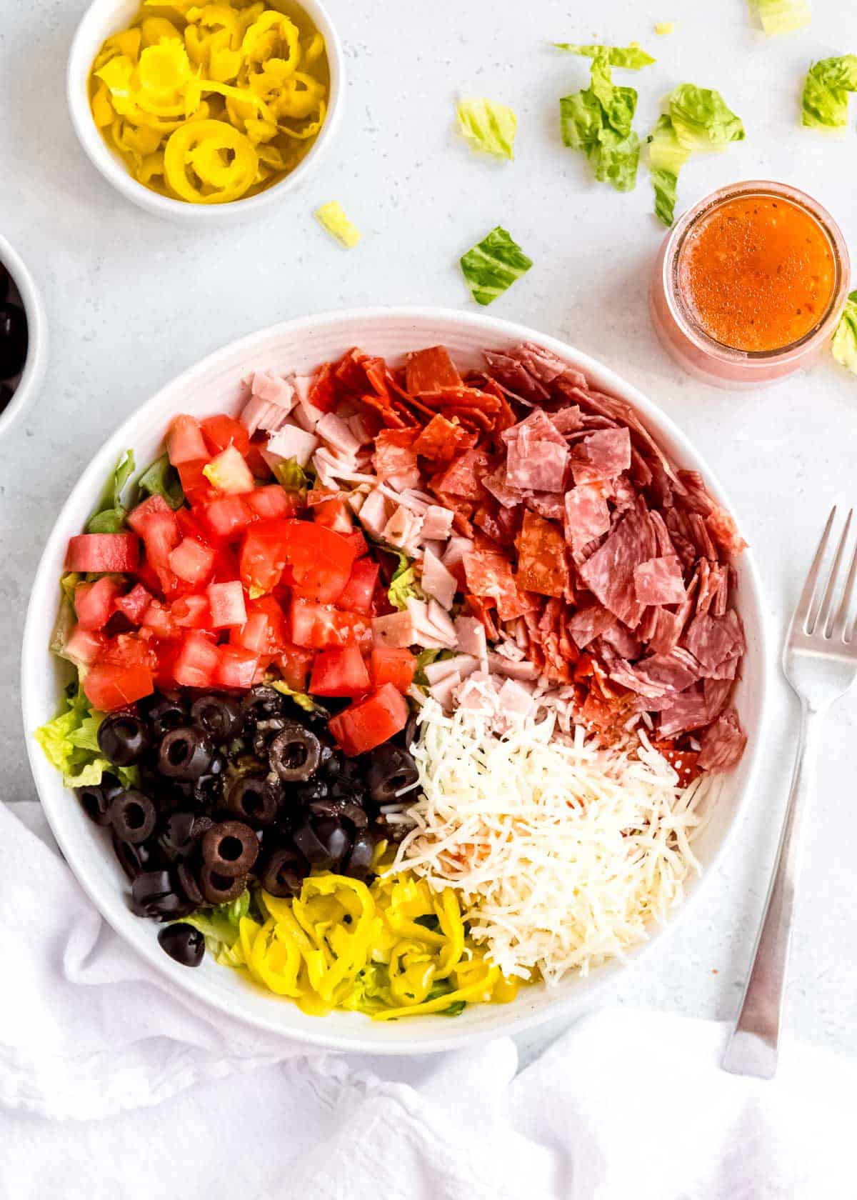 all italian sub in a tub ingredients in a white bowl on a white table