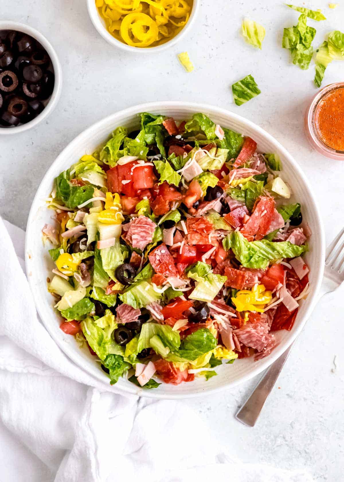 overhead image of italian sub in a tub in a white bowl with a fork