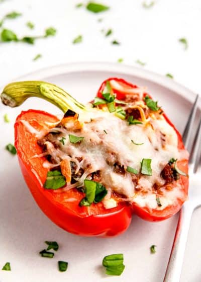 close up, side image of lasagna stuffed pepper on white plate