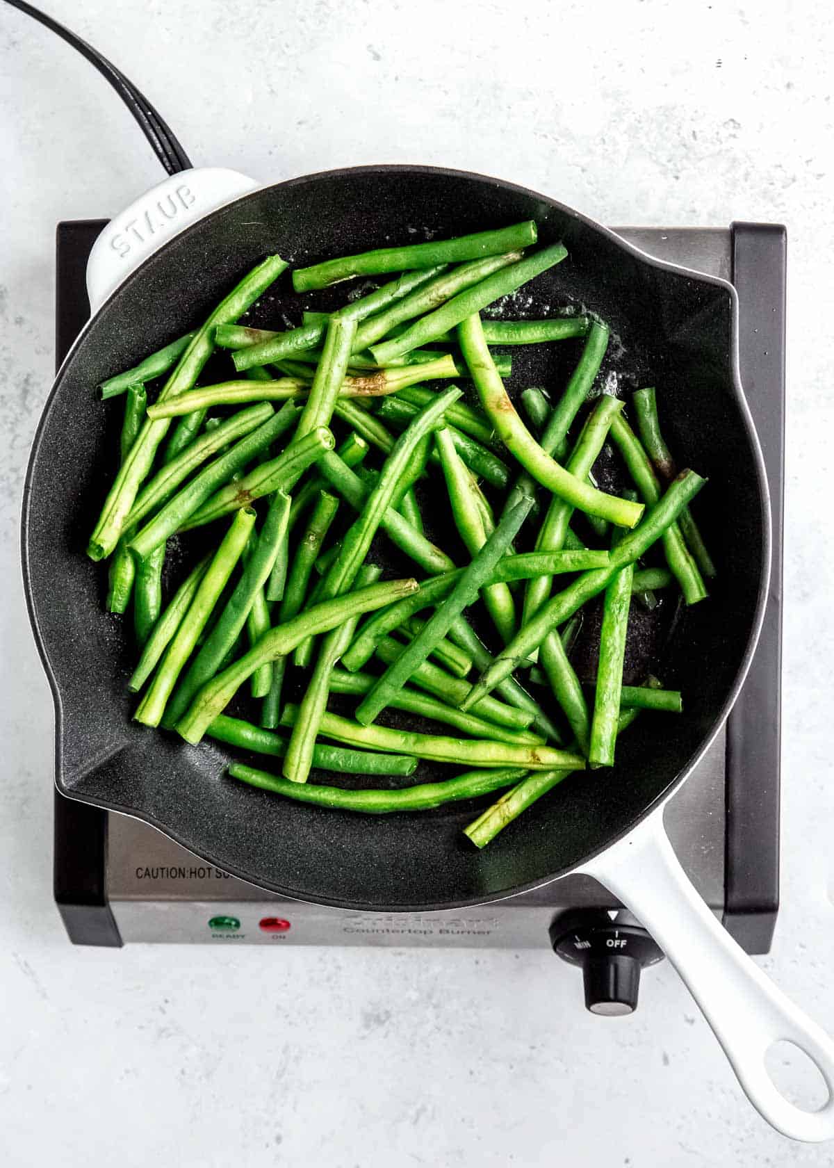 overhead image of green beans in a skillet