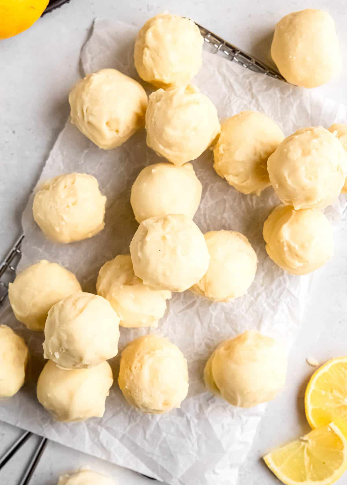 overhead image of lemon truffles stacked across a white counter top