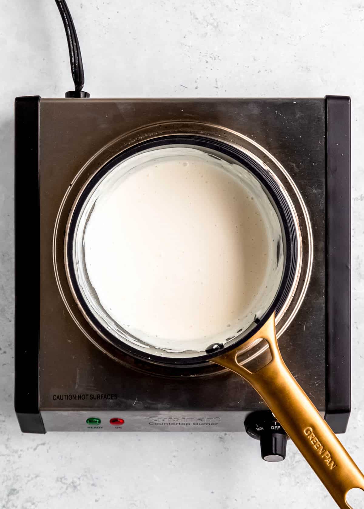 overhead image of cream cheese and heavy cream in saucepan