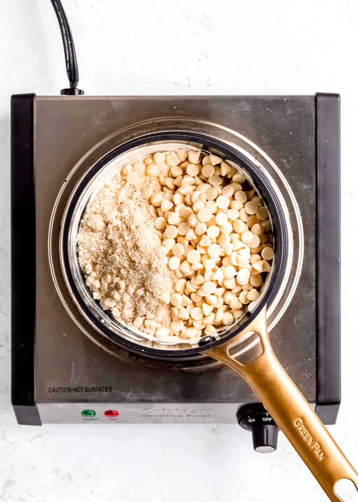 white chocolate chips being added to saucepan