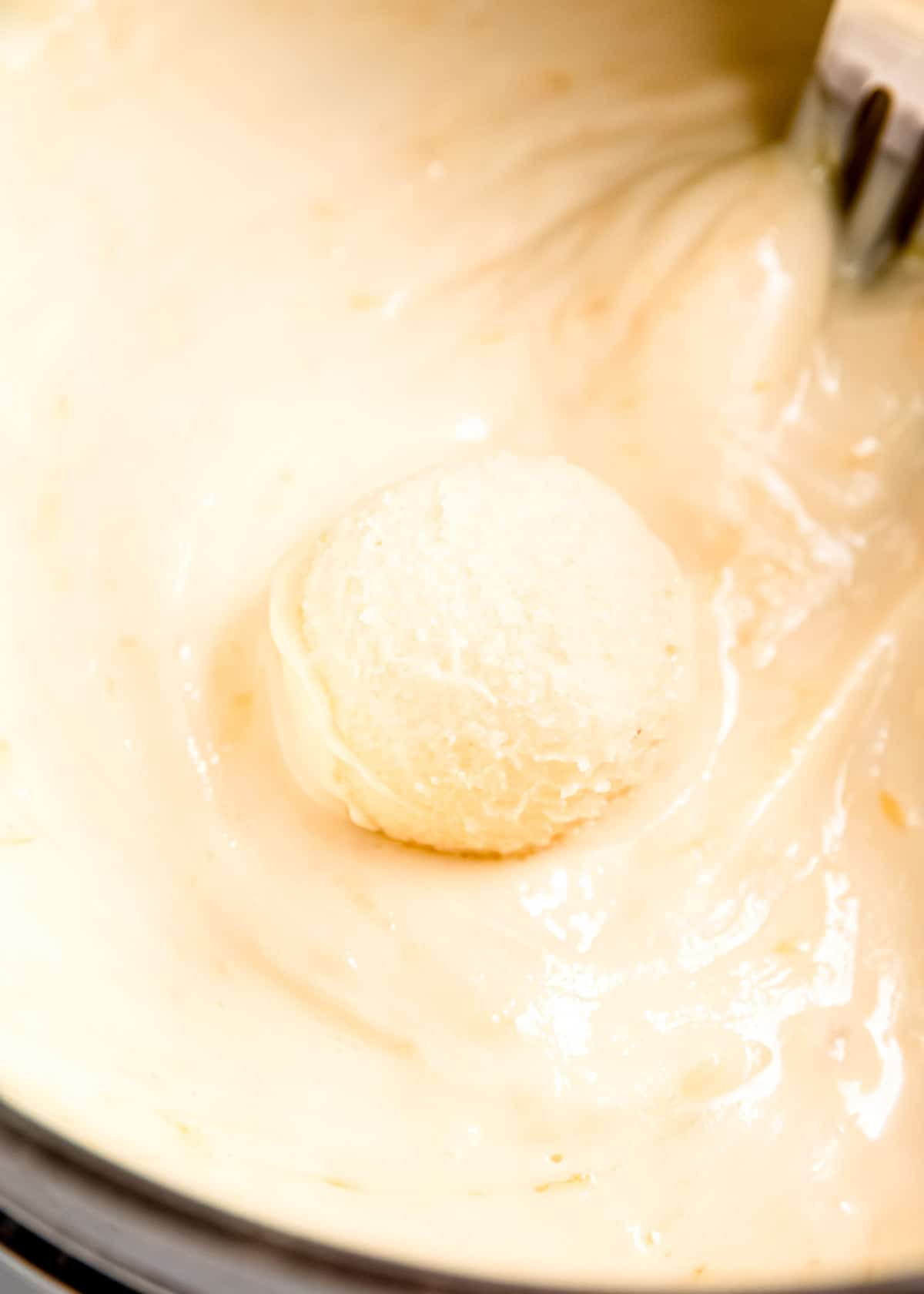 lemon truffle being coated with chocolate coating