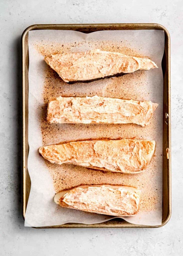 mayonnaise being added to halibut filets