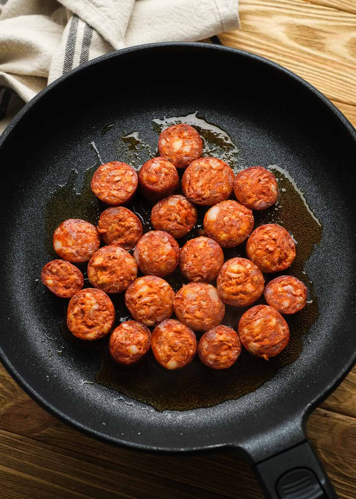 uncooked sausage in a cast iron skillet