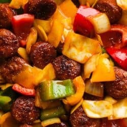 close up image of sausage and peppers with cabbage