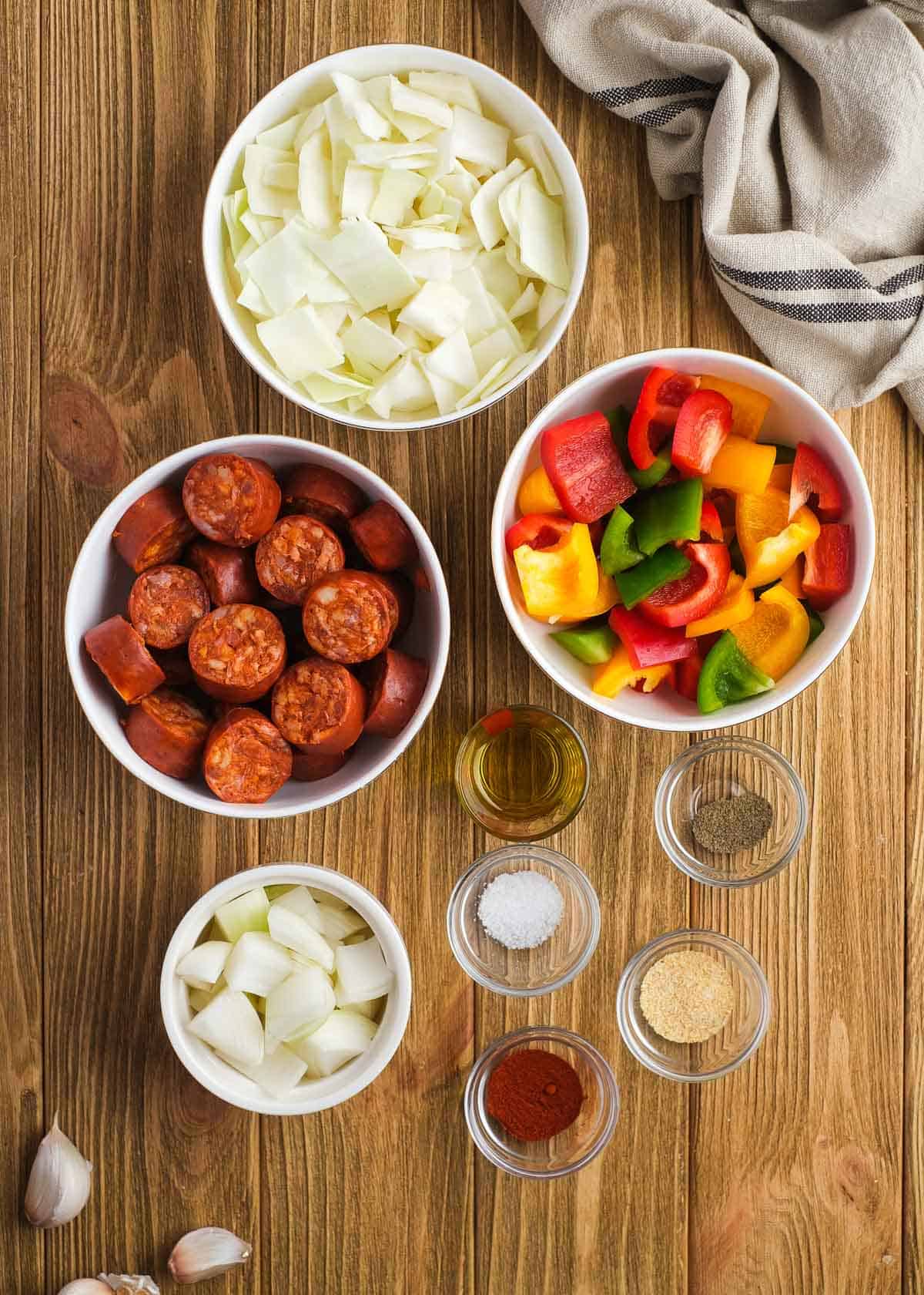 sausage and peppers with cabbage ingredients on a wooden table