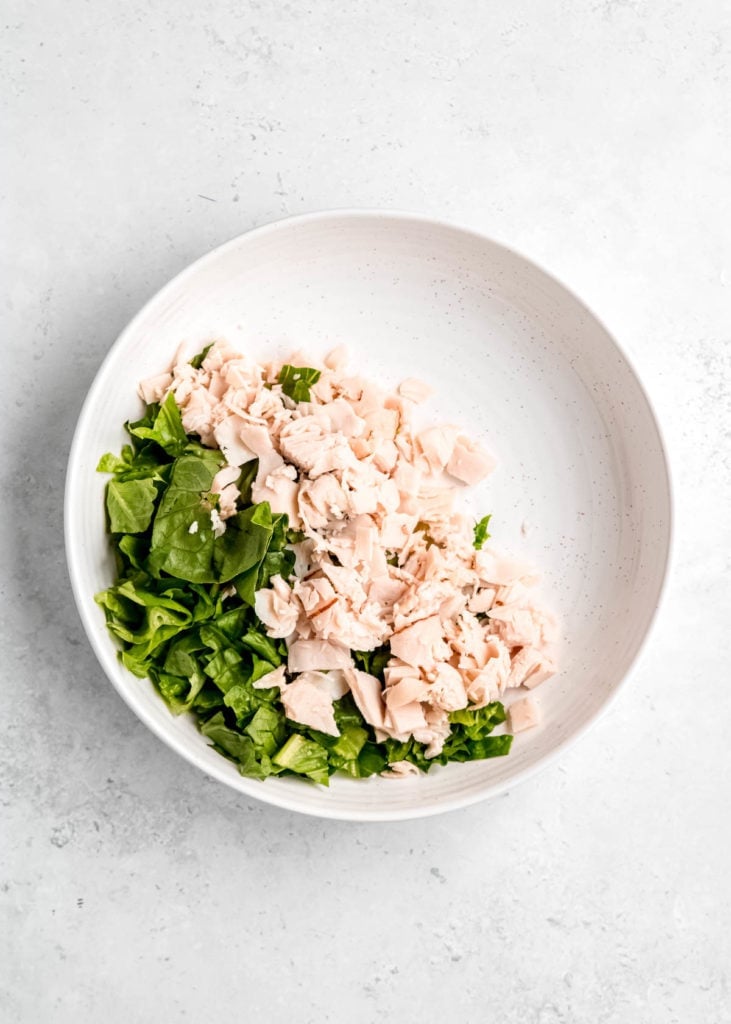 chicken and lettuce in a white bowl