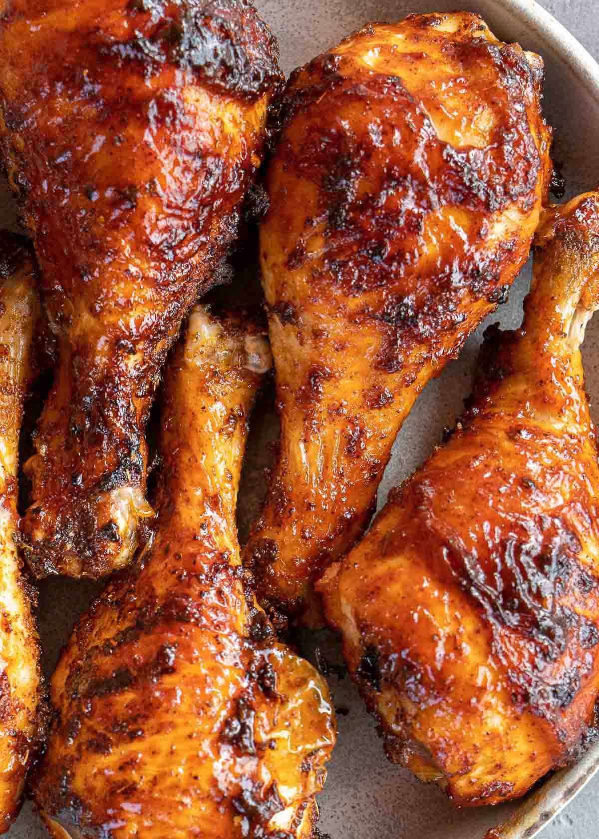 a platter filled with crispy BBQ chicken legs from the air fryer