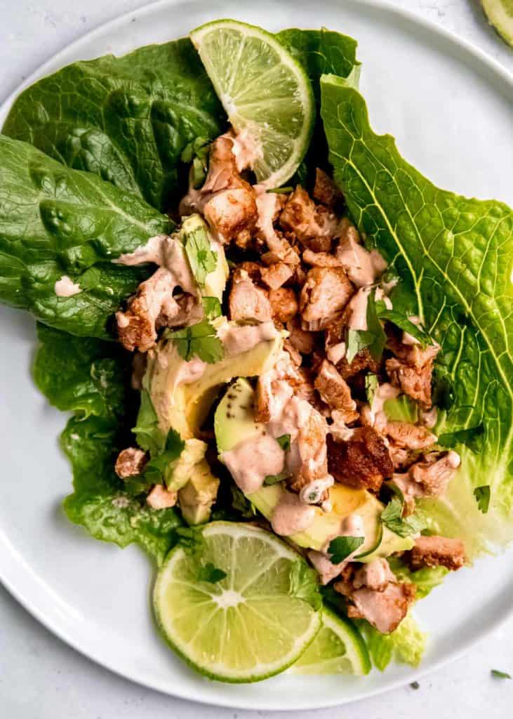 closeup of juicy chipotle chicken lettuce wraps with creamy avocado and chipotle cream sauce