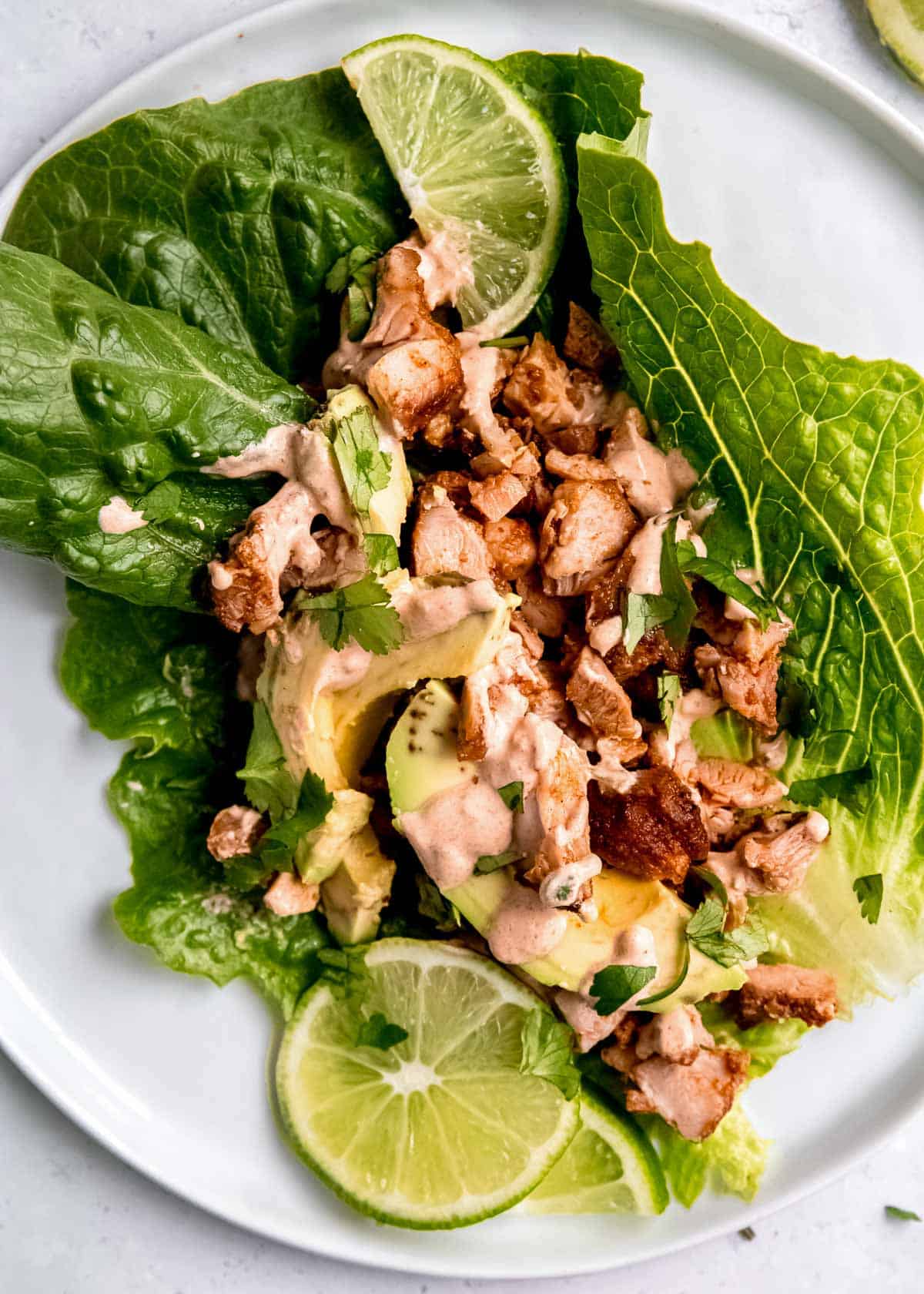 closeup of juicy chipotle chicken lettuce wraps with creamy avocado and chipotle cream sauce