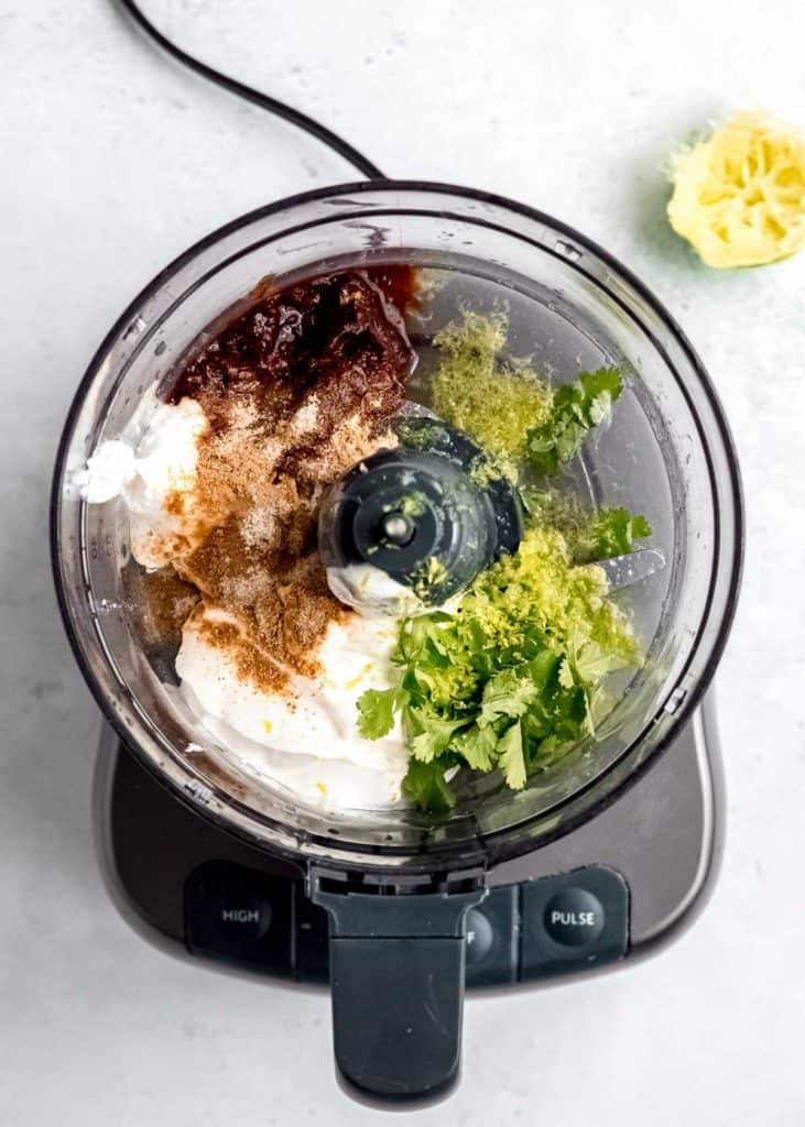 greek yogurt, chipotle peppers, lime, and other ingredients for chipotle sauce in a food processor