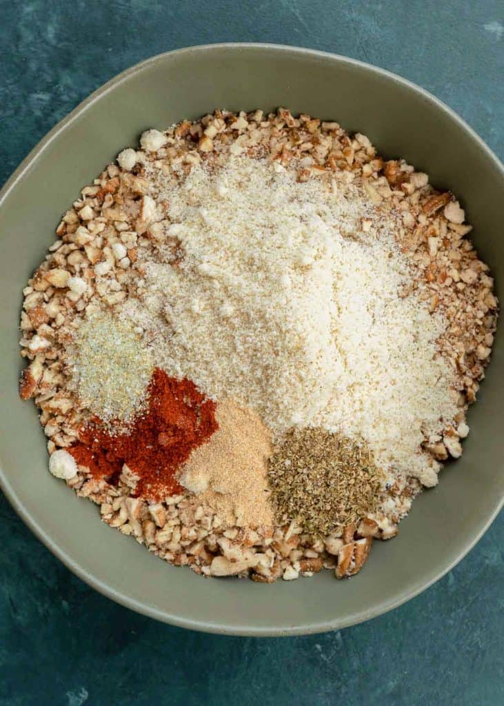 crushed pecans mixed with other keto breading ingredients for crispy crunchy chicken strips