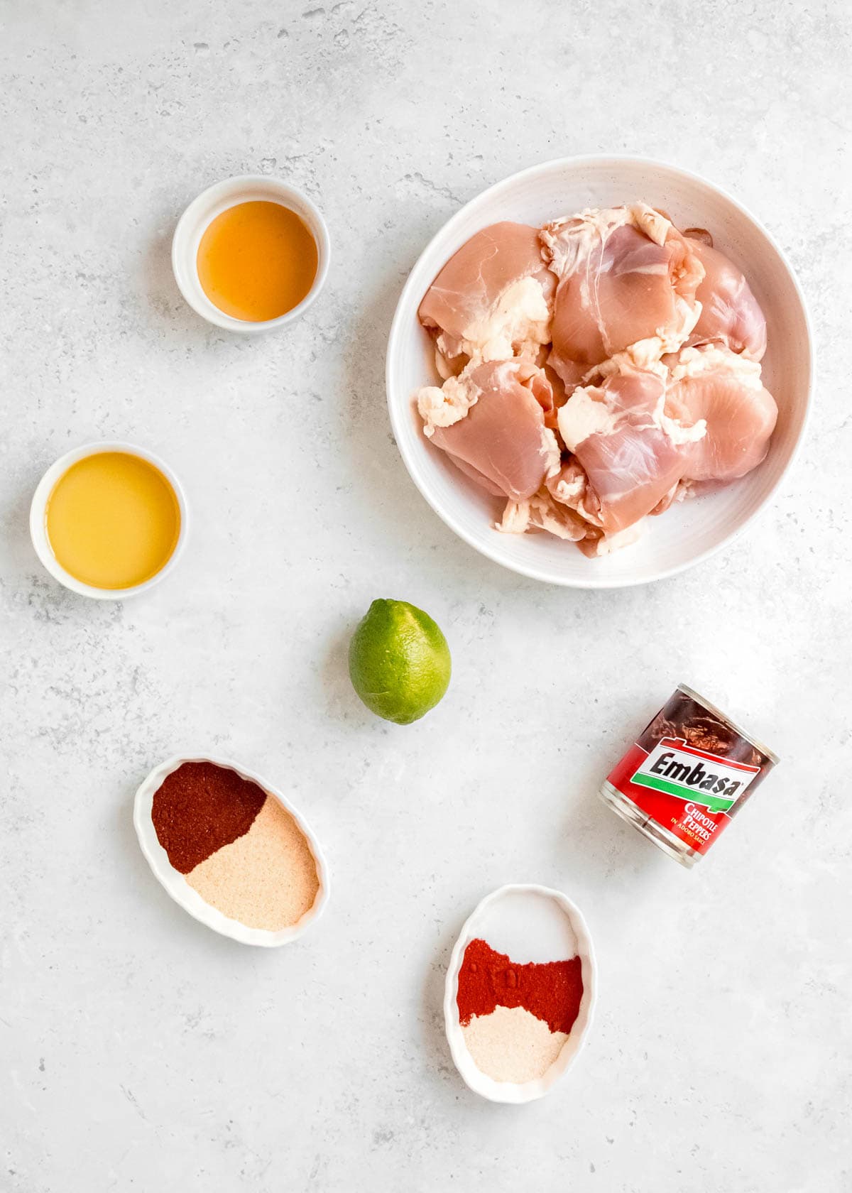 all ingredients needed for grilled chipotle chicken on a white background
