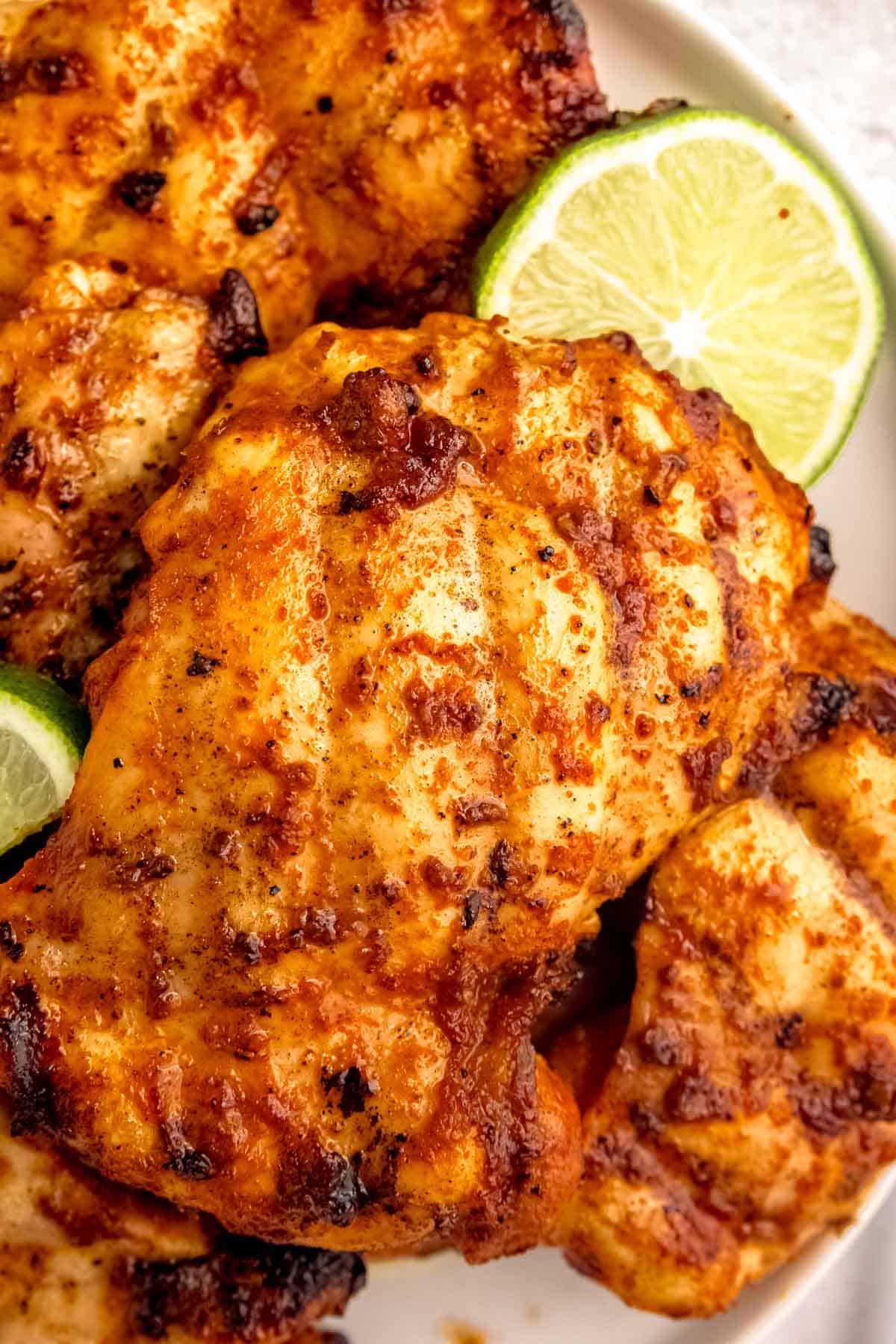 closeup view of juicy grilled chipotle chicken and lime slices