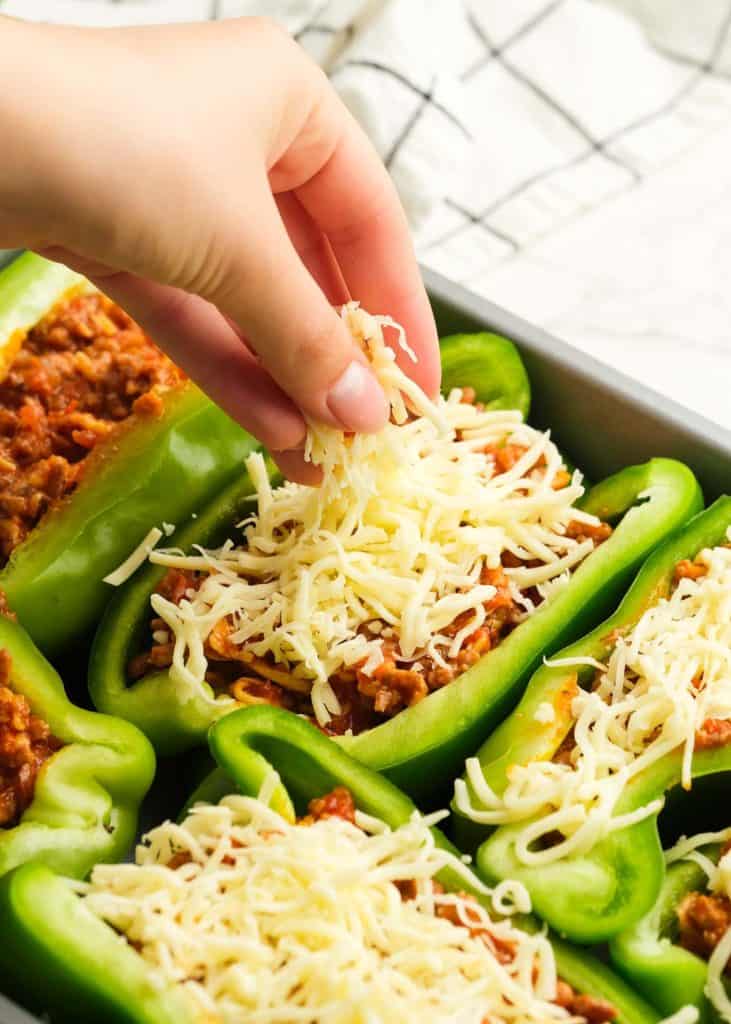 pizza stuffed bell peppers topped with shredded mozzarella cheese