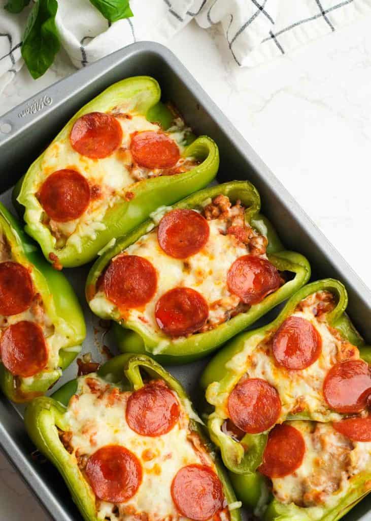 cooked pizza stuffed peppers with melty cheese and crispy pepperoni in a baking dish