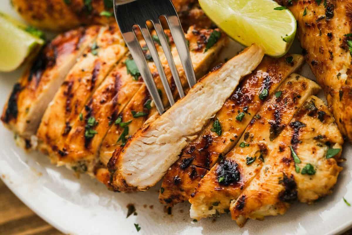 closeup view showing how juicy this grilled cilantro lime chicken is after marinating