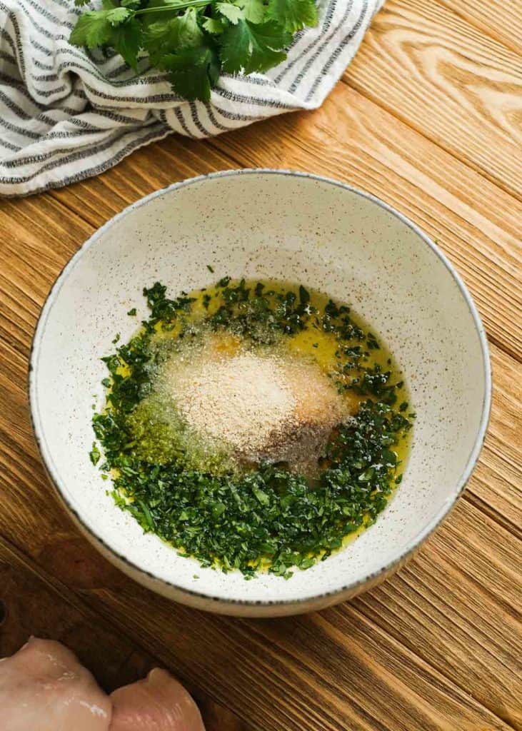 avocado oil, cilantro, lime juice, lime zest, and seasonings in a bowl for an easy chicken marinade