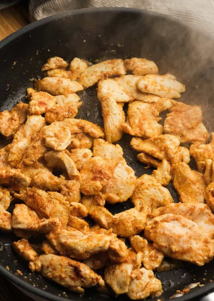 browned chicken in a cast iron skillet