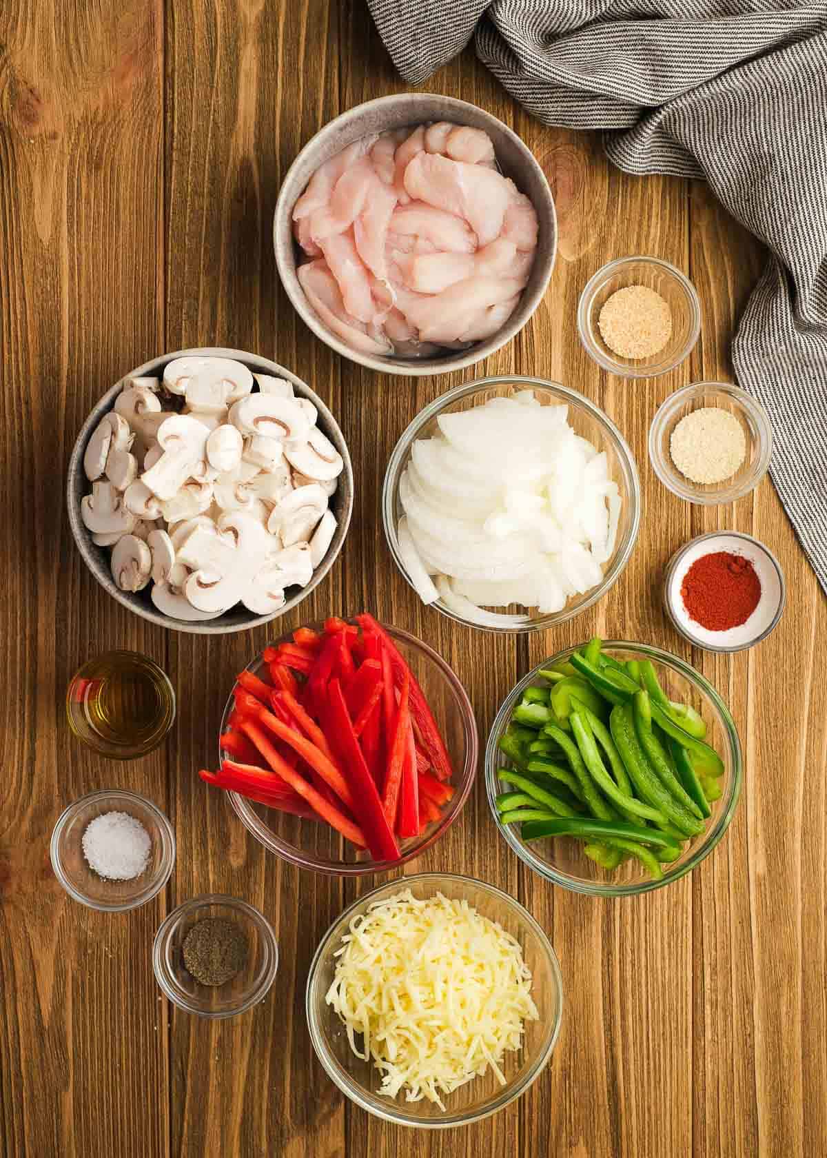 chicken cheesesteak ingredients on a wooden table