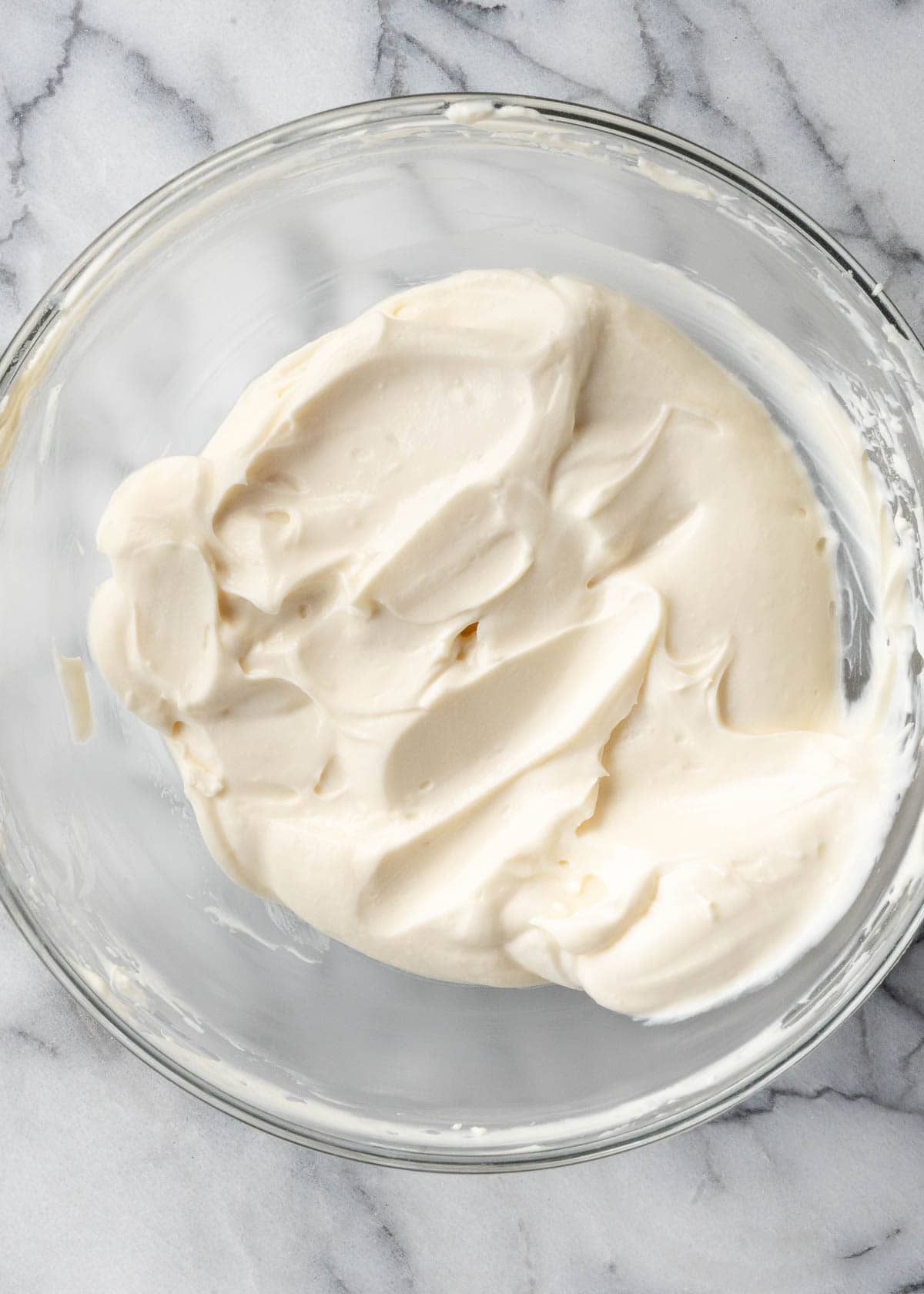 cream cheese frosting in a clear bowl