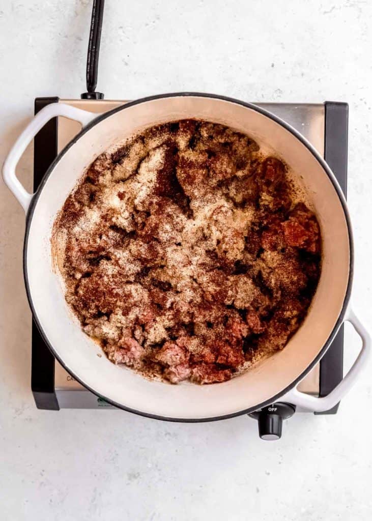 ground beef and spices in a dutch oven