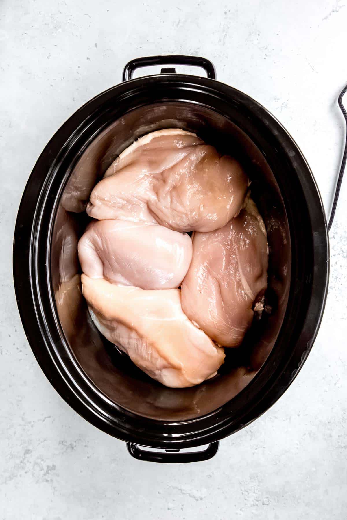 overhead shot of chicken breast in a crockpot