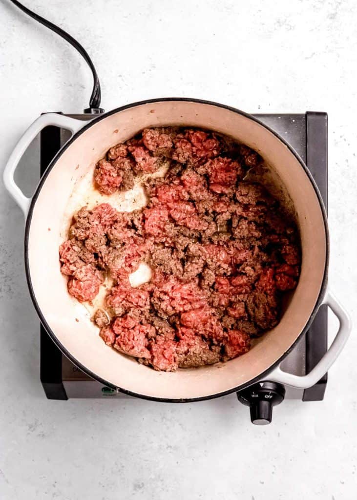 ground beef being browned in dutch oven