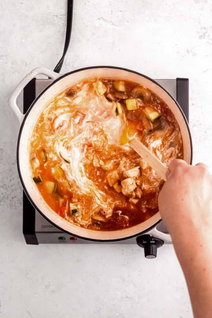 lime juice being added to thai curry chicken soup