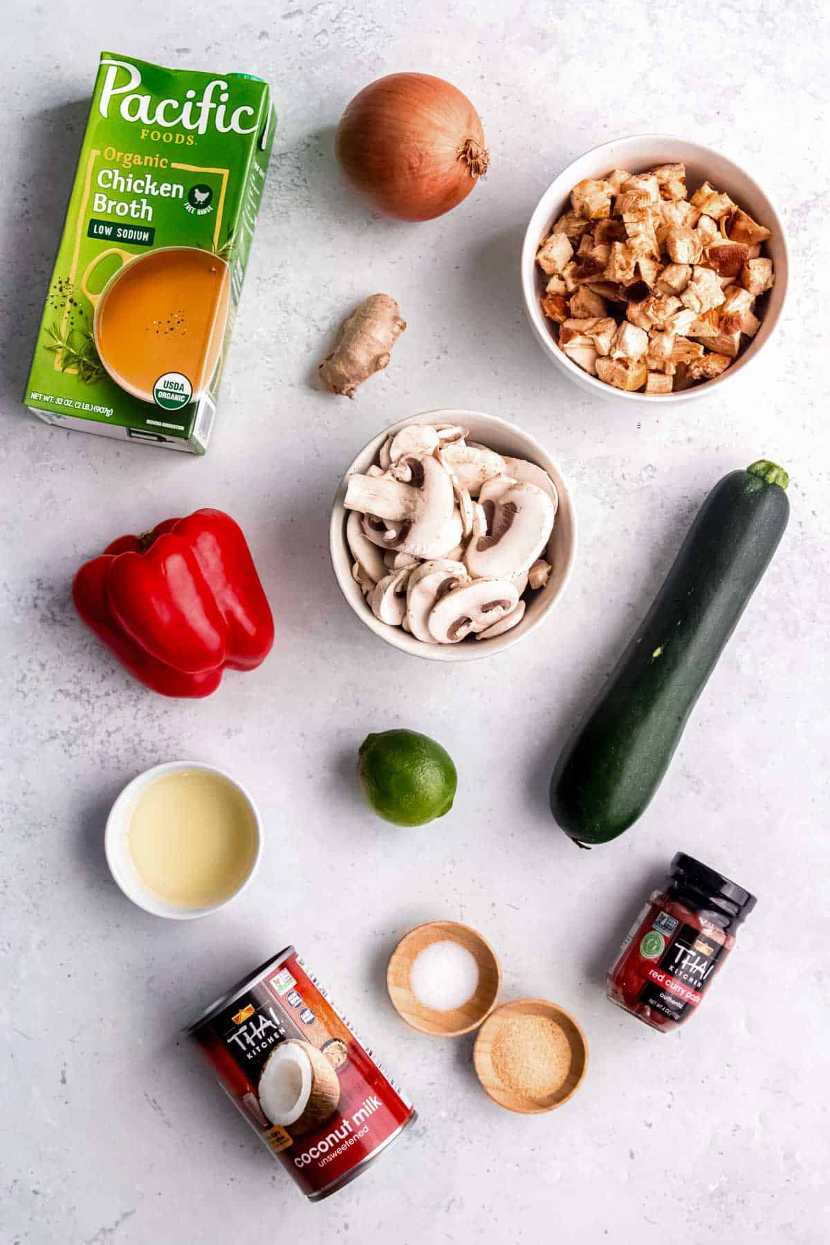 thai curry chicken soup ingredients on a white table