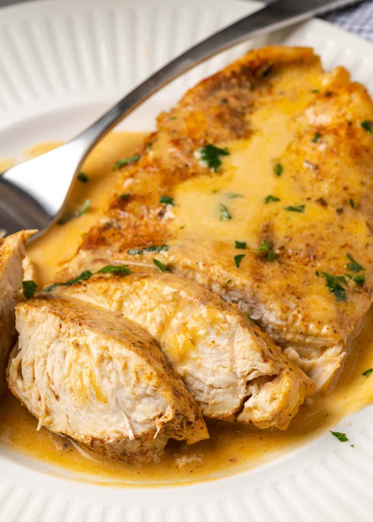 a sliced chicken breast in a creamy cajun chicken sauce