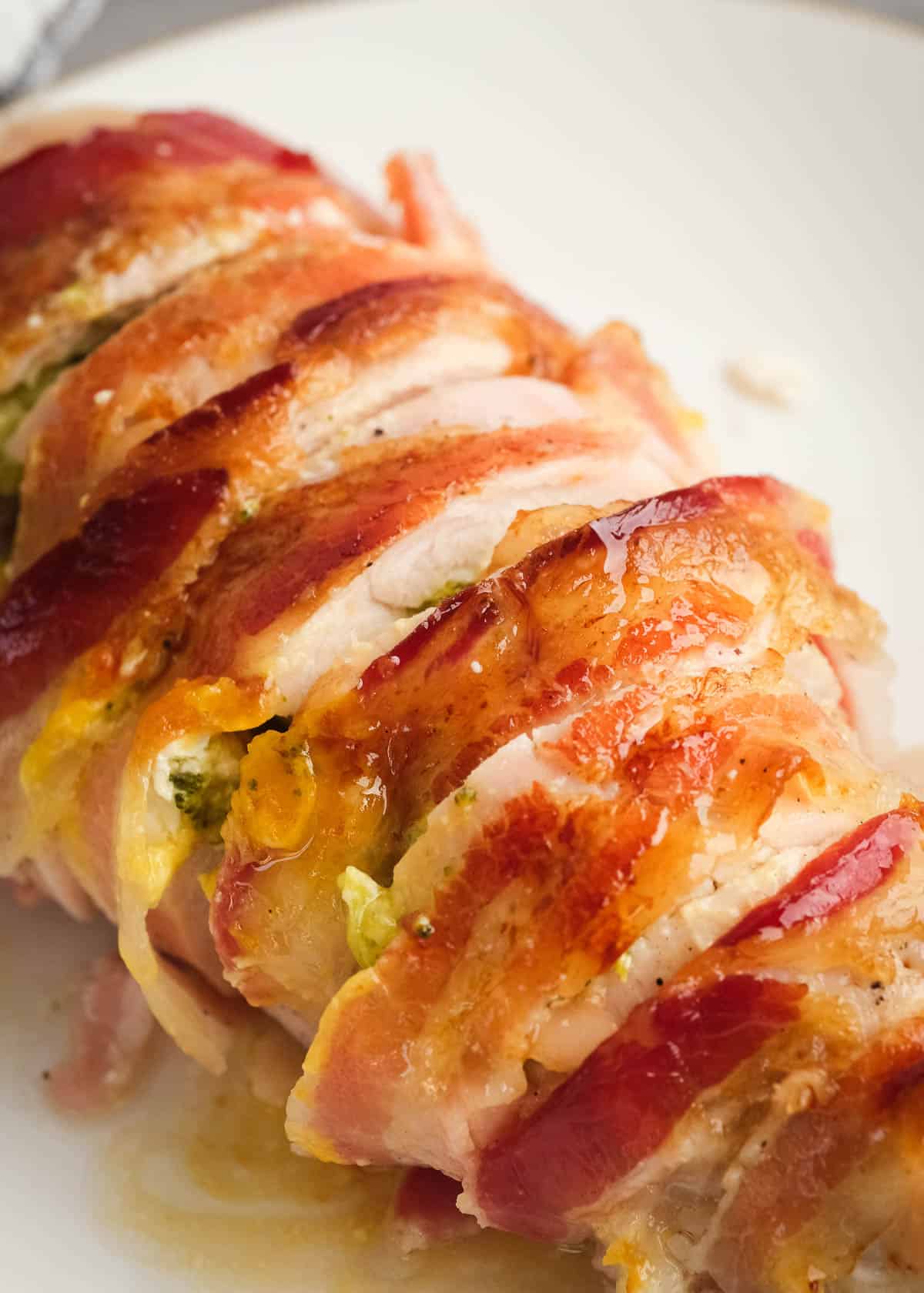 overhead image of sliced bacon wrapped stuffed chicken