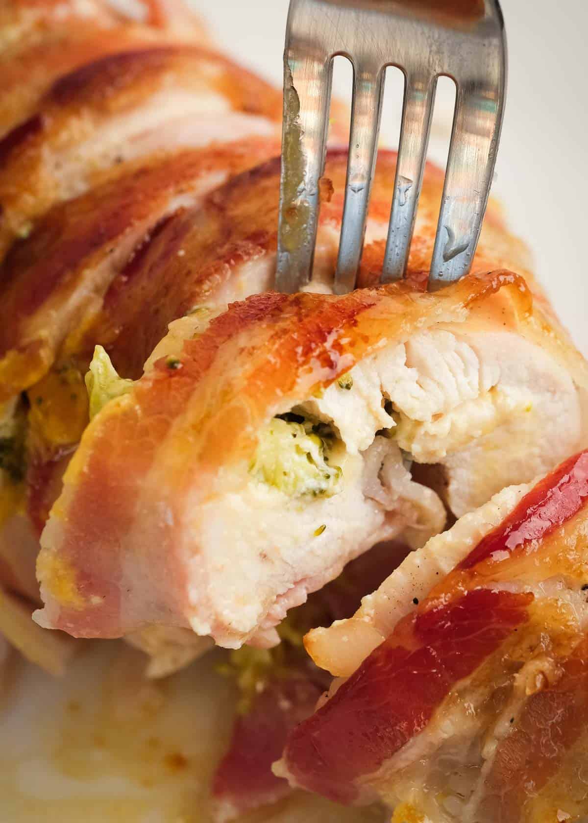 close up image of sliced, chicken breast with one slice being removed with fork