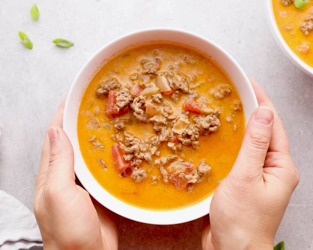 overhead image of cheeseburger soup in white bowl