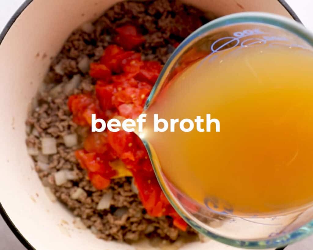 beef broth being added to cheeseburger soup