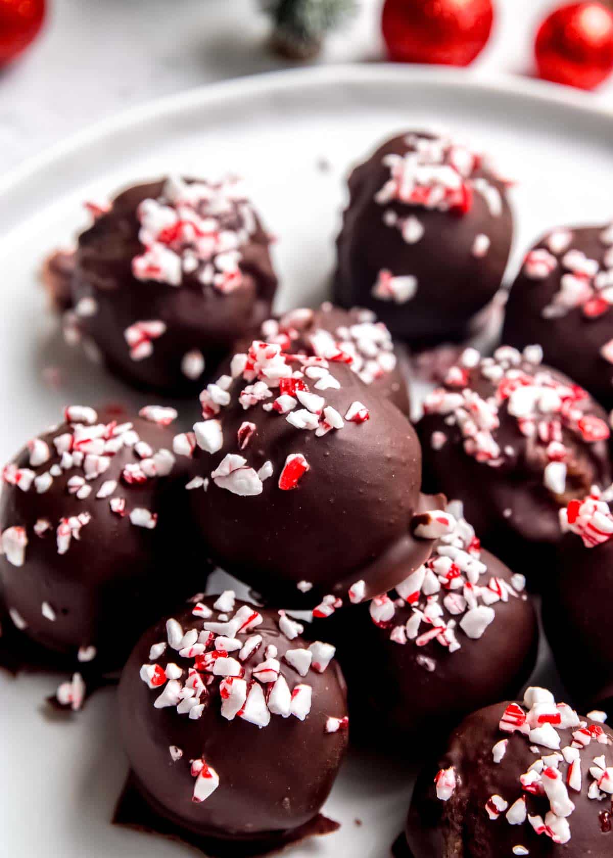 angled image of peppermint mocha truffles on white plate