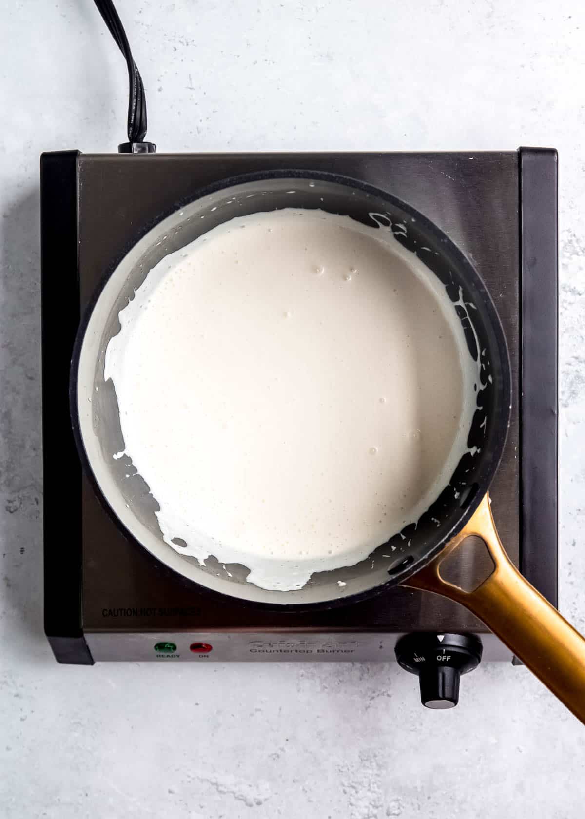 cream cheese and heavy cream in sauce pan after mixing