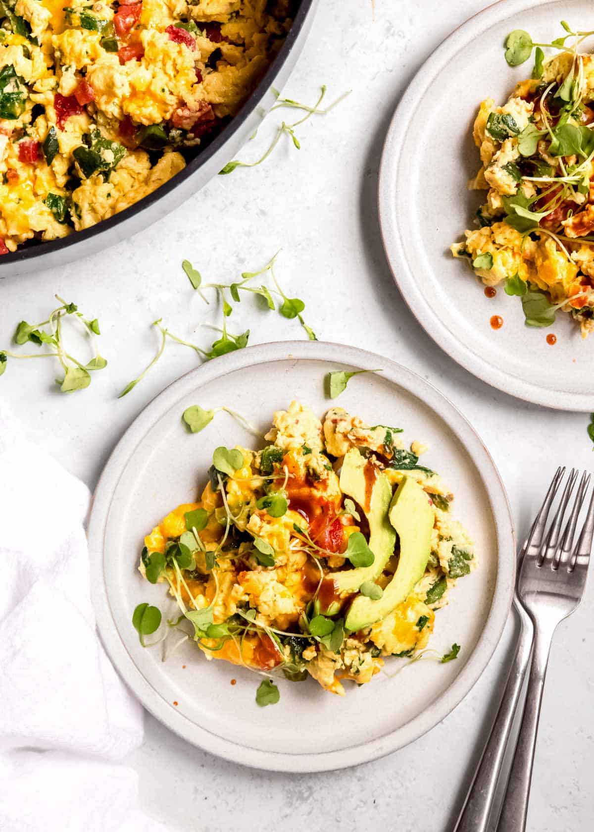 overhead image of California scramble on white plate and fork on white table