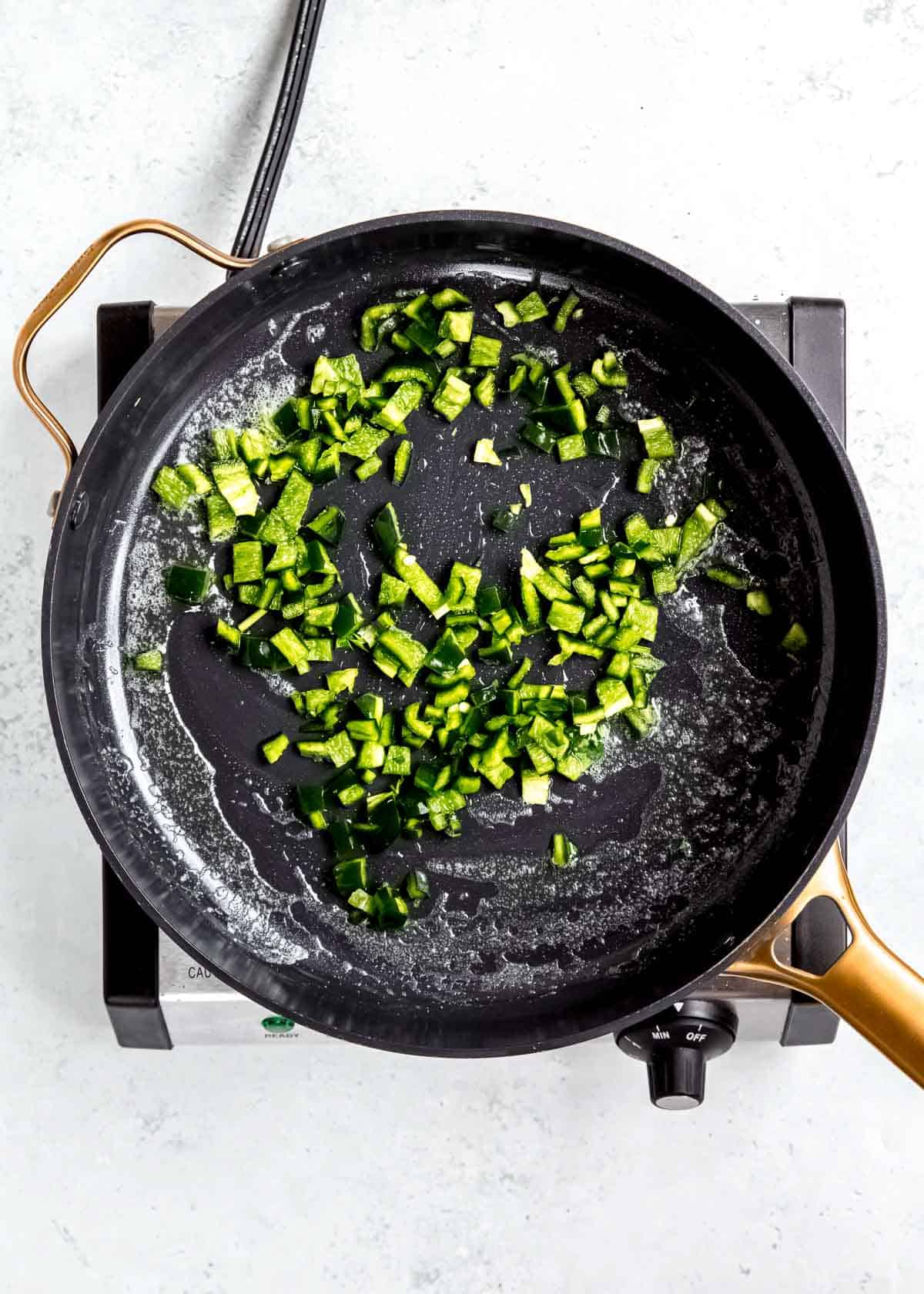diced pepper in a black skillet