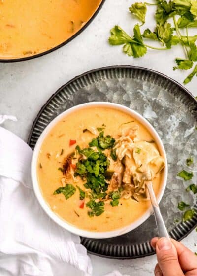 overhead image of chile relleno soup in white bowl on silver platter