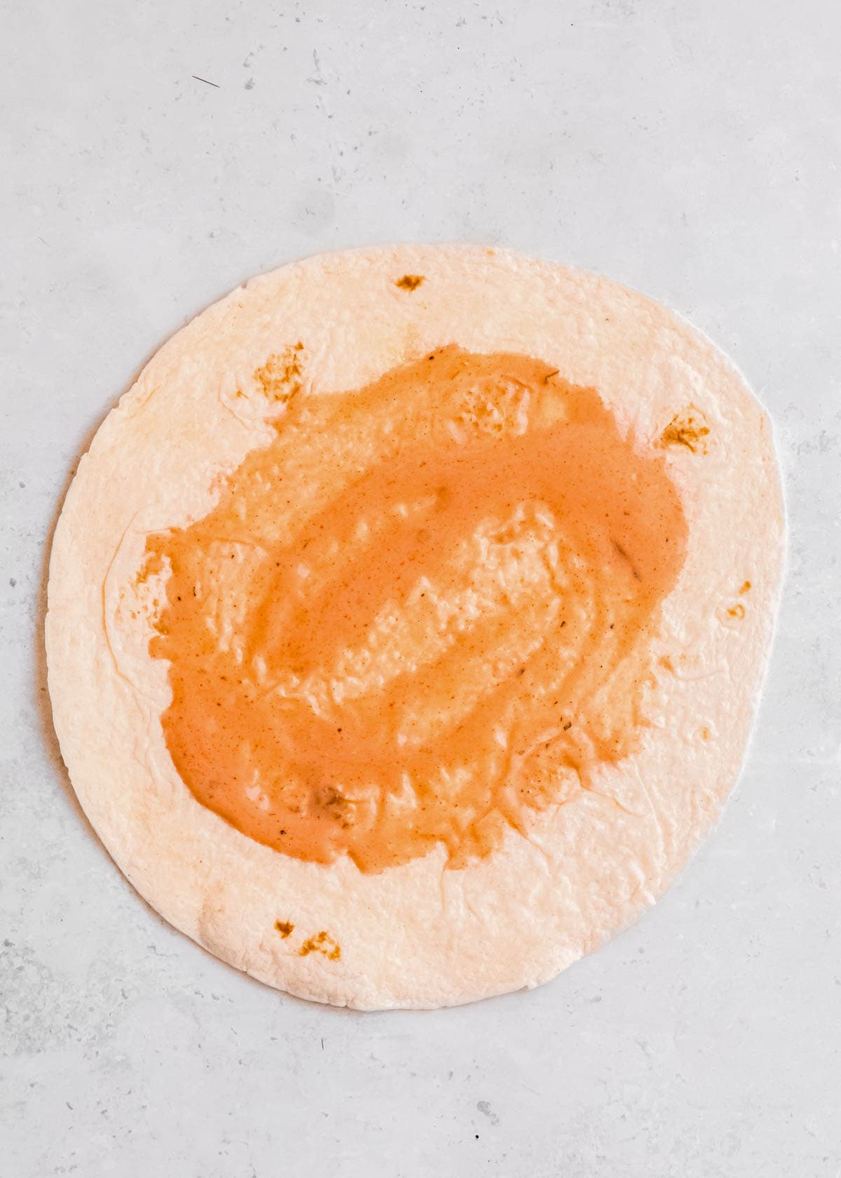 buffalo mixture spread over a tortilla