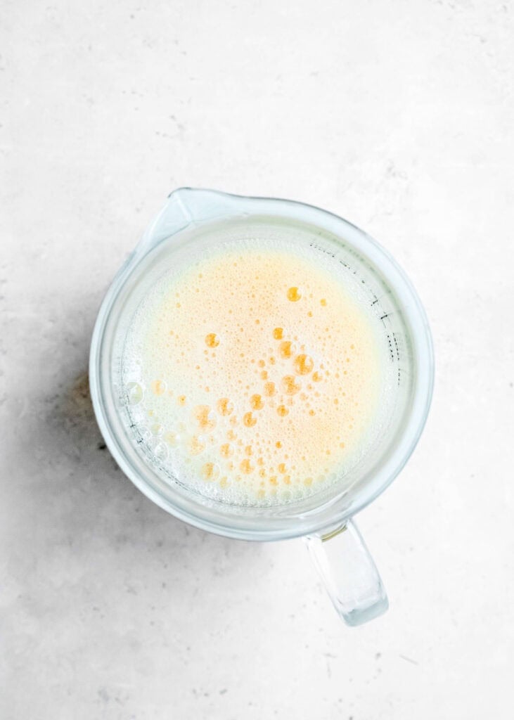 chicken broth and xanthan gum in clear mixing bowl