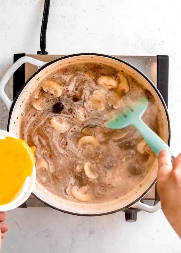 eggs being added to hot and sour soup