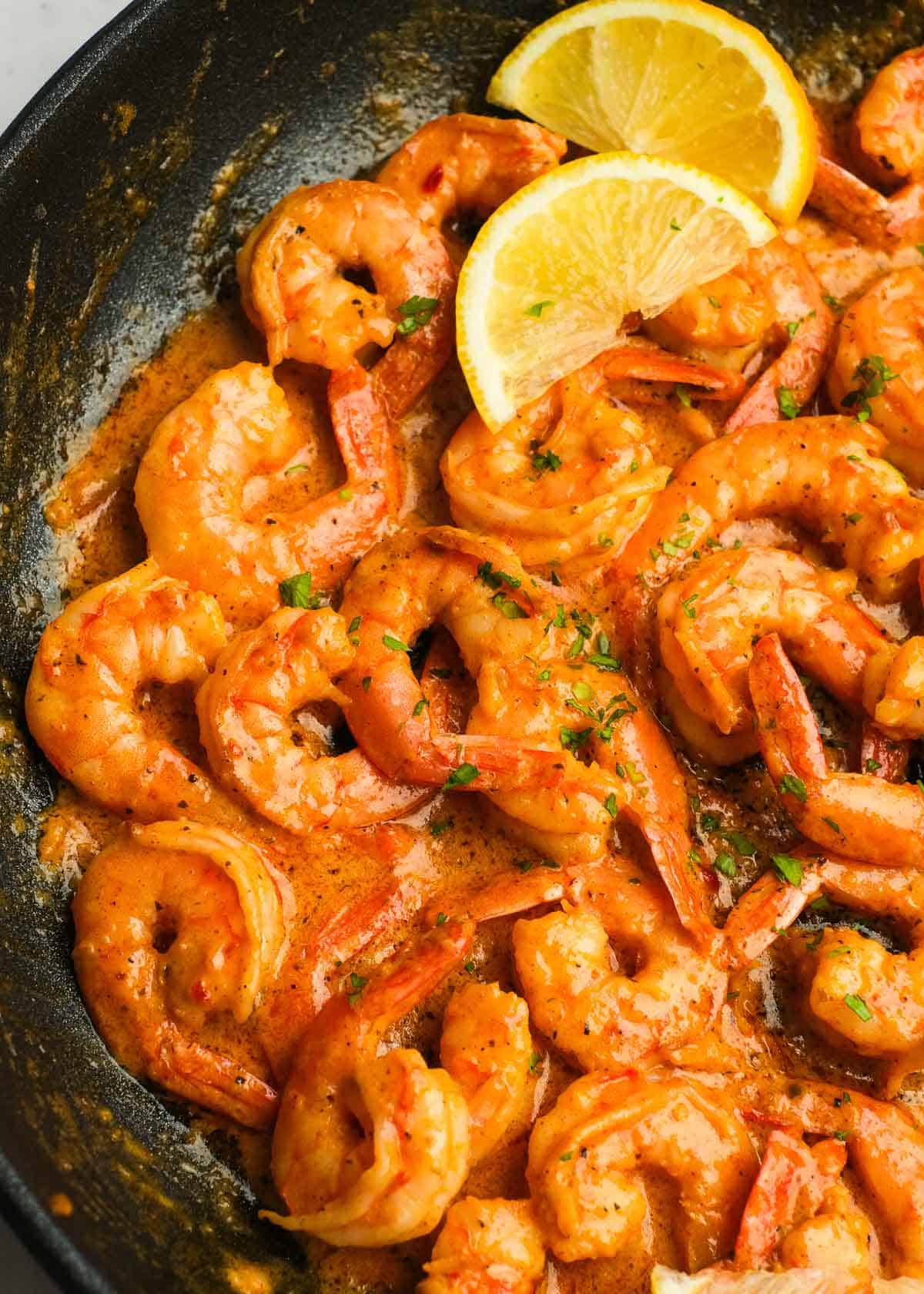 overhead image of cajun shrimp in a cast iron skillet