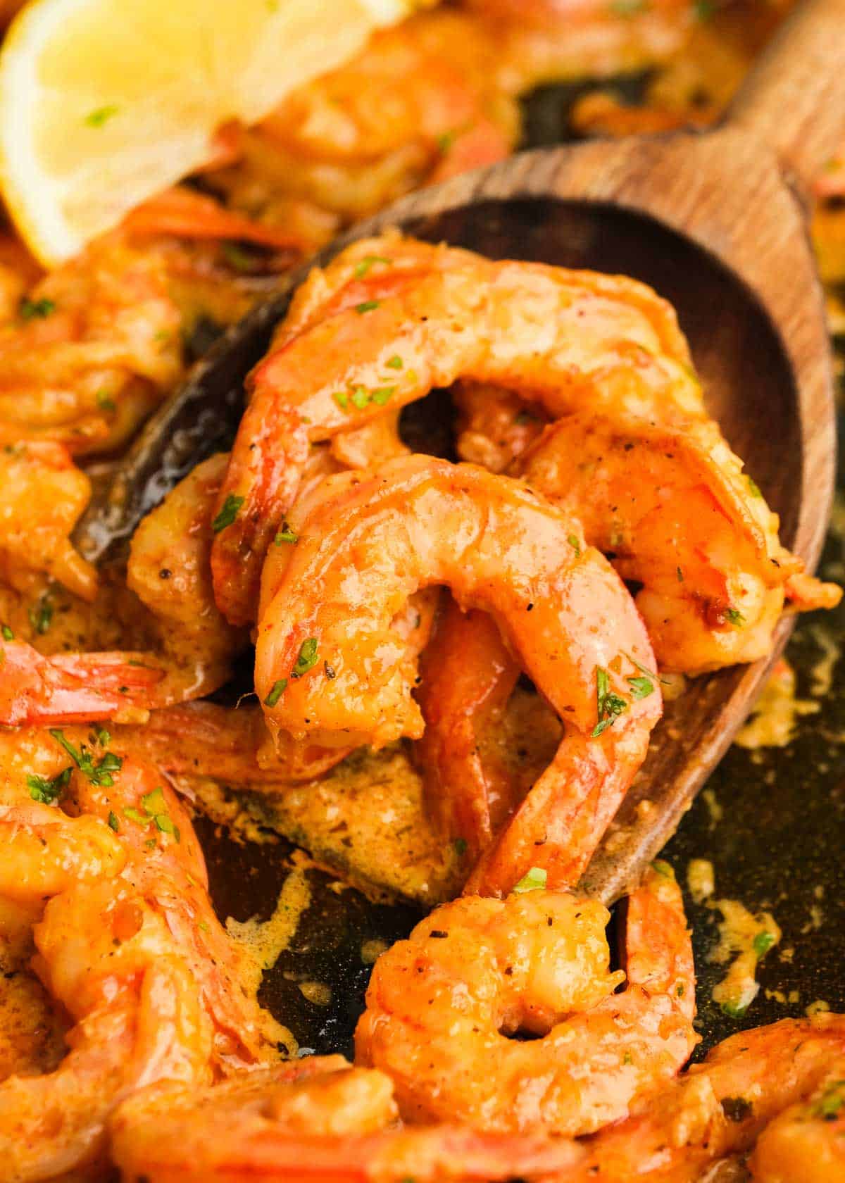 close up image of cooked cajun shrimp in cast iron skillet