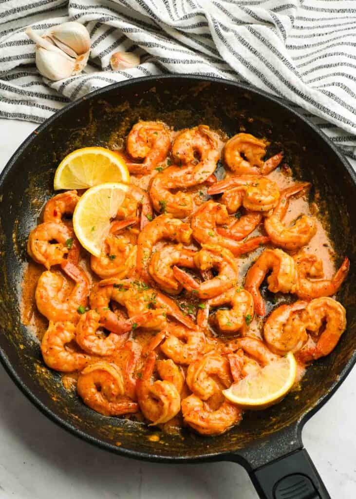 cajun shrimp cooking in cast iron skillet