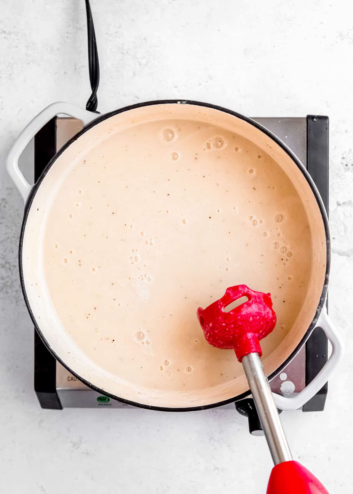 thickened cauliflower soup after being blended in dutch oven