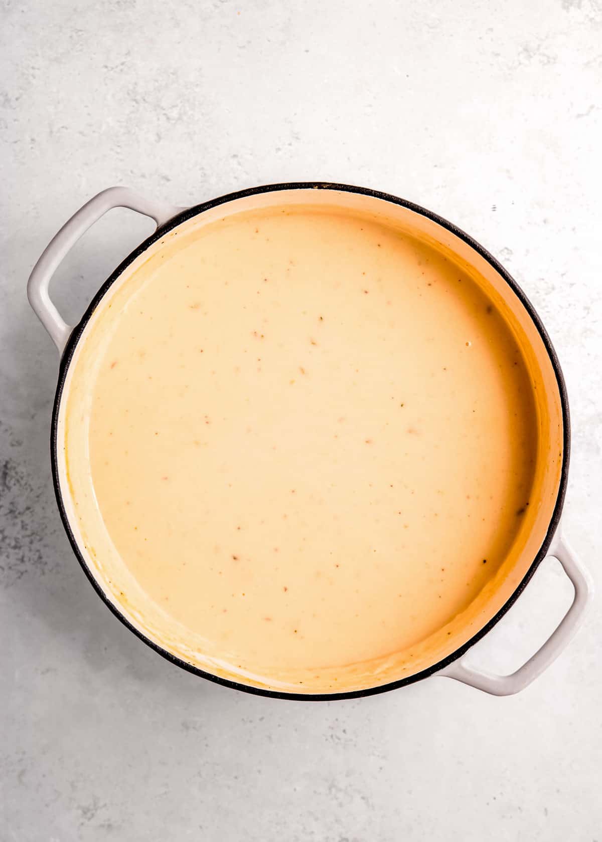 loaded cauliflower soup in dutch oven prior to garnishing